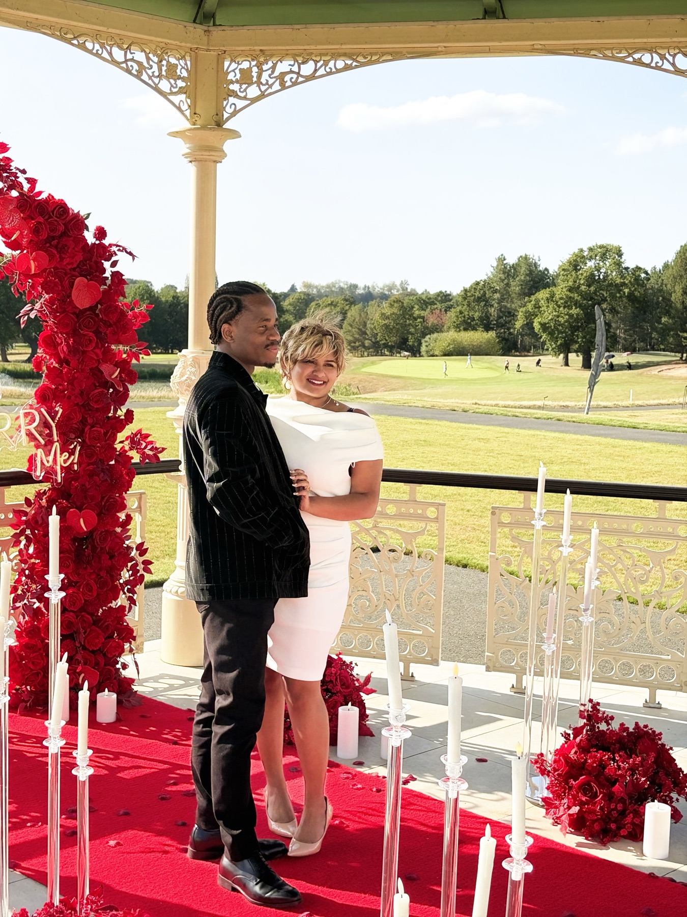 Victor and Andrea posing together at the gazebo where he proposed